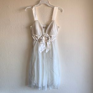 Glittery white dress with a bow.